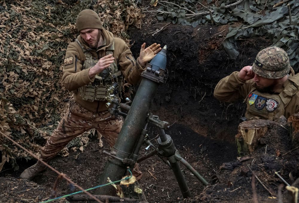 Ukrainian members of the 28th Separate Mechanized Brigade fire a 120-mm mortar toward Russian troops